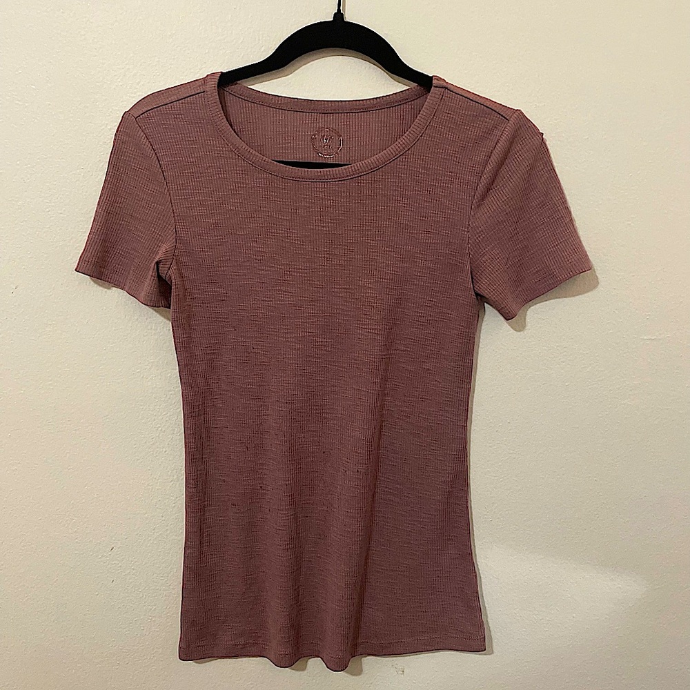 formfitting shorts sleeve, lightly worn, has been washed and markings are faded